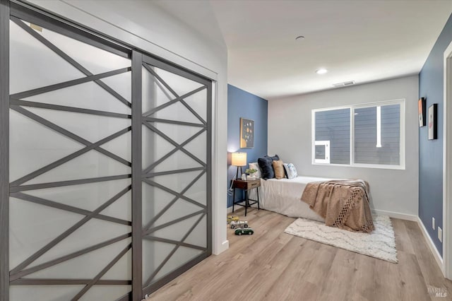 unfurnished bedroom with recessed lighting, wood finished floors, visible vents, and baseboards