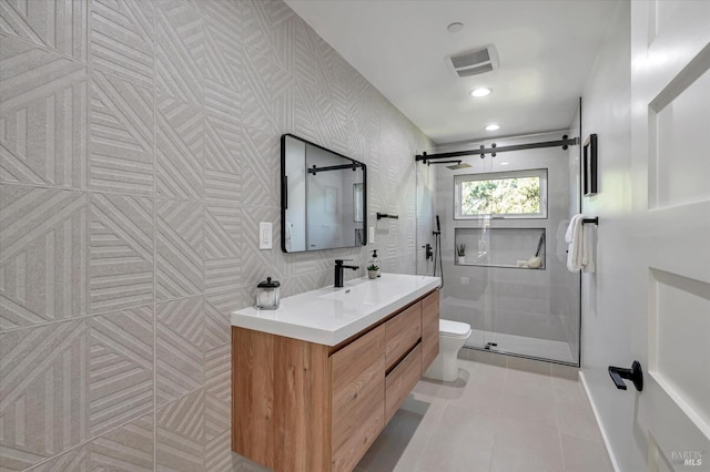 full bathroom with visible vents, toilet, a stall shower, vanity, and tile patterned floors