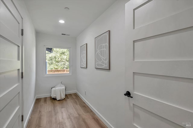 interior space with light wood-style floors, visible vents, baseboards, and recessed lighting