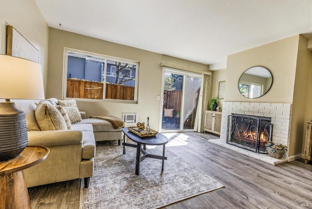 living area with a fireplace and wood finished floors