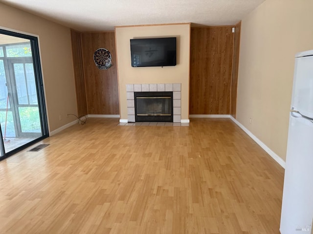761 Isabella Way, Fairfield, CA 94533 - unfurnished living room featuring baseboards, a tiled fireplace, light wood-style flooring, and visible vents