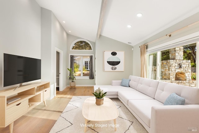 living area with a healthy amount of sunlight, light wood-style flooring, baseboards, and recessed lighting