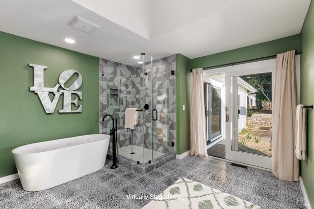 full bath with recessed lighting, granite finish floor, baseboards, a freestanding bath, and a shower stall