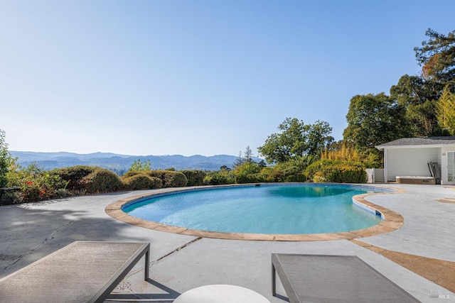 pool with a mountain view and a patio