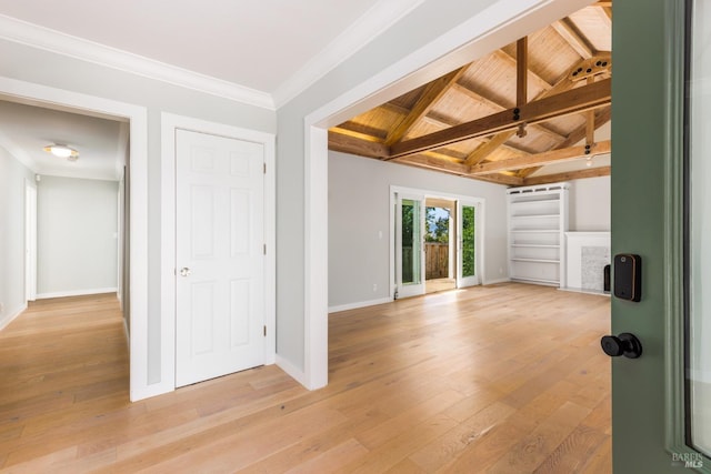 empty room with baseboards, lofted ceiling with beams, wooden ceiling, light wood-style flooring, and ornamental molding