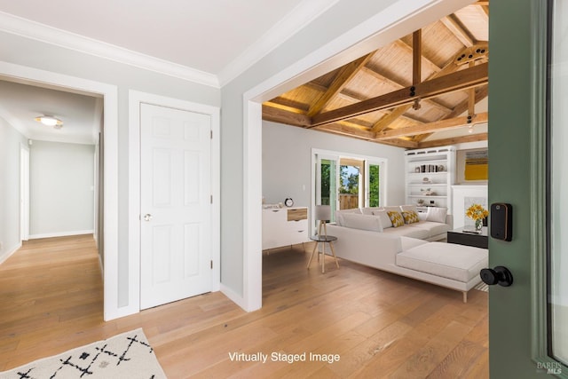 interior space featuring vaulted ceiling with beams, light wood finished floors, wooden ceiling, and crown molding