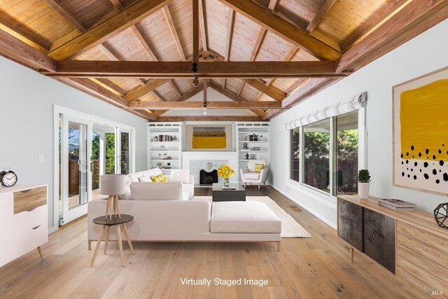 sunroom featuring lofted ceiling with beams, plenty of natural light, a fireplace, and wood ceiling