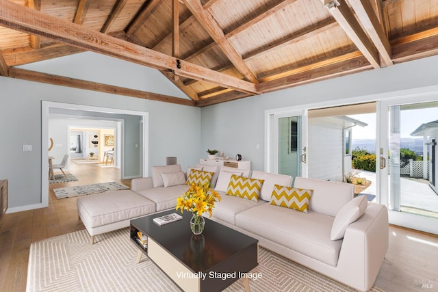 living area with lofted ceiling with beams, hardwood / wood-style flooring, wood ceiling, baseboards, and french doors