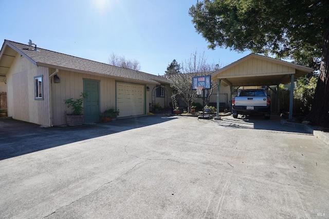 ranch-style home featuring aphalt driveway and an attached garage