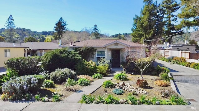 ranch-style home featuring fence