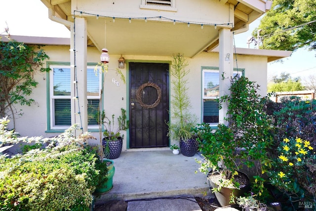 entrance to property featuring stucco siding