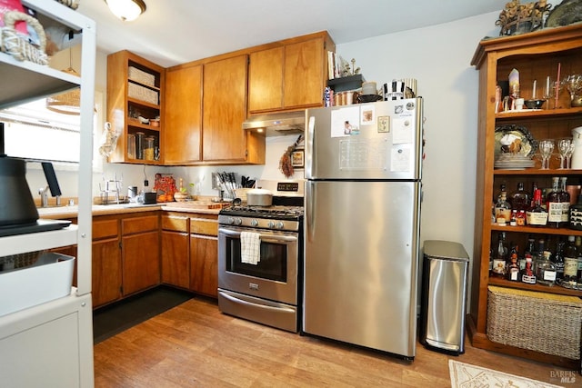 kitchen featuring stainless steel appliances, light wood-style flooring, under cabinet range hood, and open shelves