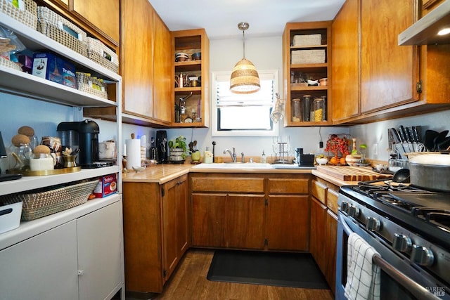 kitchen with open shelves, brown cabinets, gas range, and under cabinet range hood