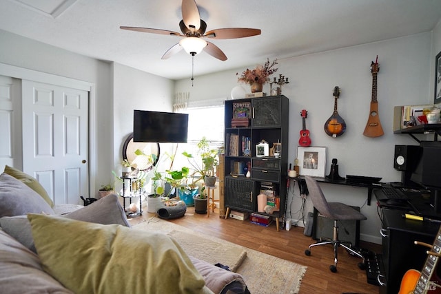 living area with ceiling fan and wood finished floors