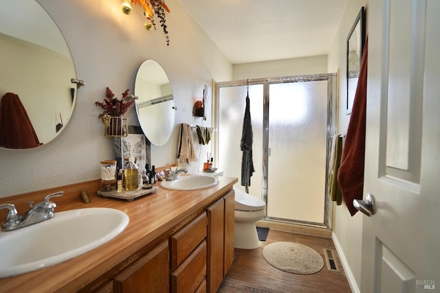 full bathroom with a stall shower, visible vents, a sink, and toilet