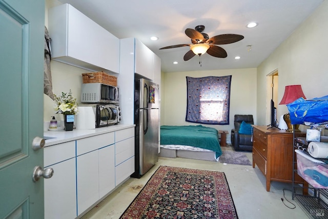 bedroom with recessed lighting, concrete floors, ceiling fan, and freestanding refrigerator