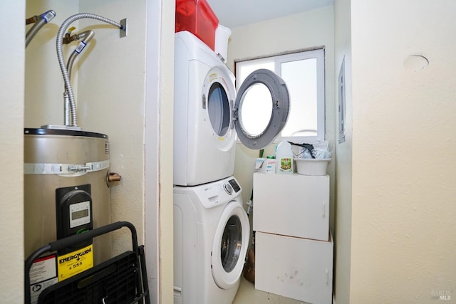 laundry room with stacked washer / dryer, secured water heater, and laundry area