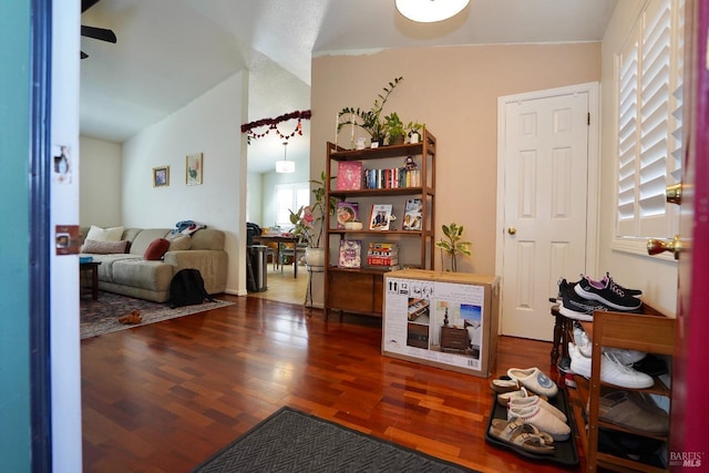 interior space featuring lofted ceiling, a ceiling fan, and wood finished floors