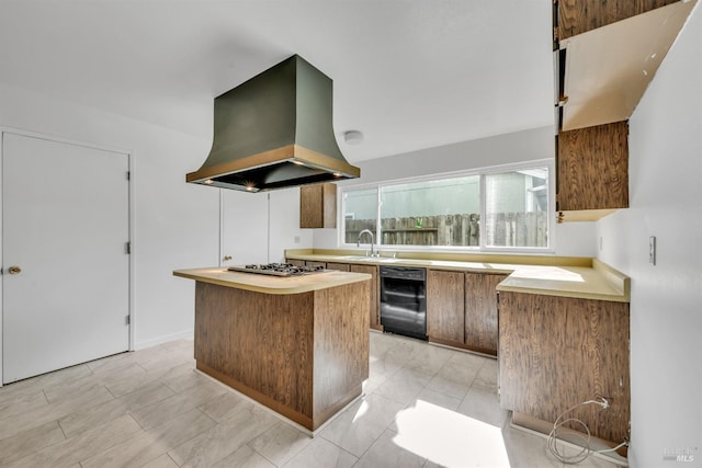 kitchen featuring stainless steel gas cooktop, a sink, light countertops, black dishwasher, and island range hood