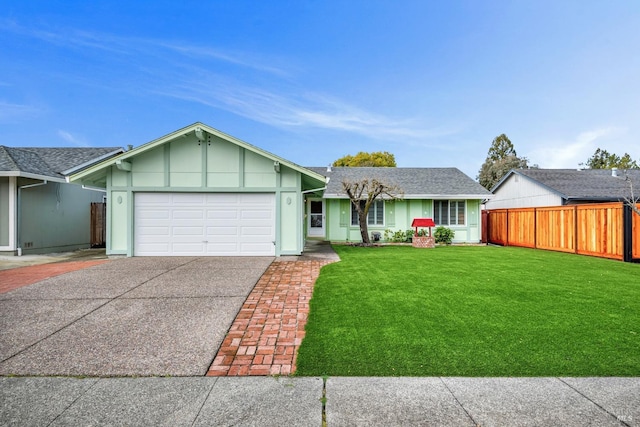 view of front of house featuring a front yard, fence, driveway, roof with shingles, and a garage