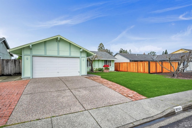 view of front of home with a garage, driveway, a front yard, and fence