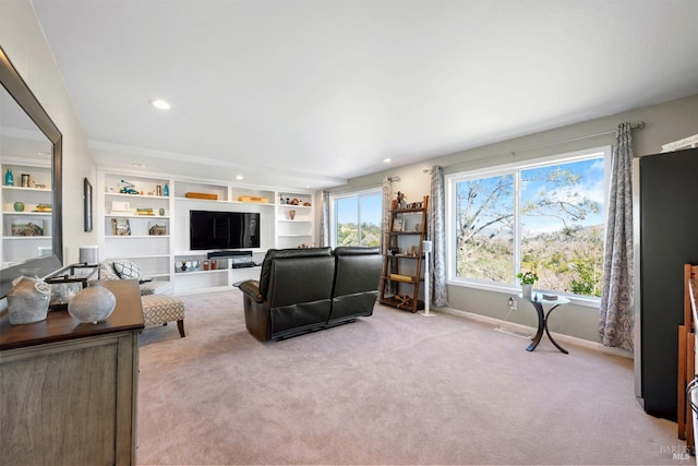 carpeted living room featuring baseboards and recessed lighting