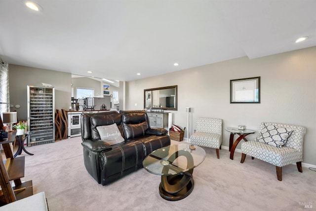 living room featuring recessed lighting, light colored carpet, and baseboards