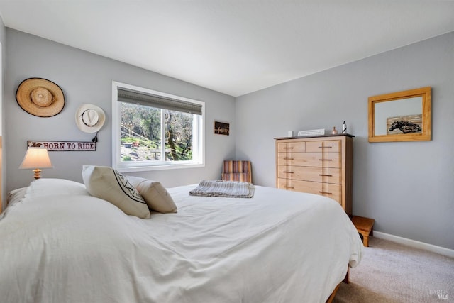 bedroom with carpet flooring and baseboards