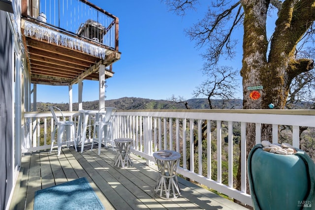 wooden deck with a mountain view