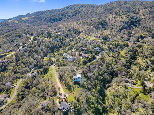 birds eye view of property with a forest view and a mountain view