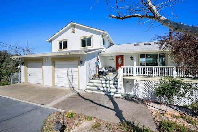 view of front of house featuring a porch, concrete driveway, and roof with shingles