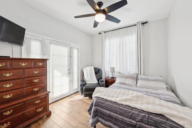 bedroom featuring ceiling fan, light wood finished floors, and access to exterior