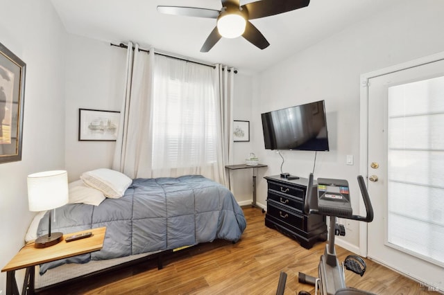 bedroom featuring ceiling fan, wood finished floors, and baseboards