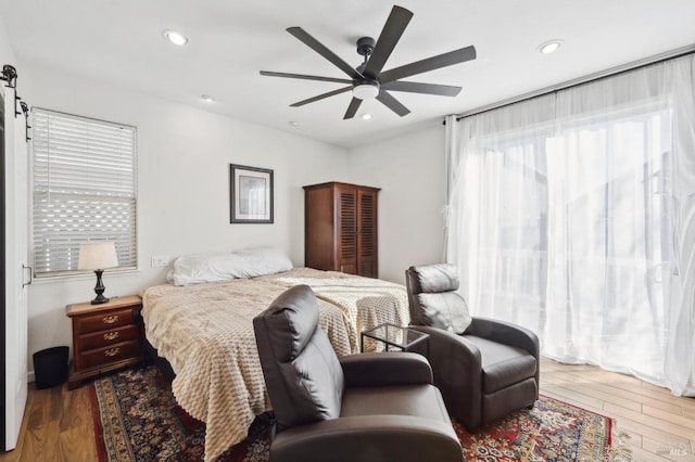 bedroom featuring ceiling fan, wood finished floors, and recessed lighting