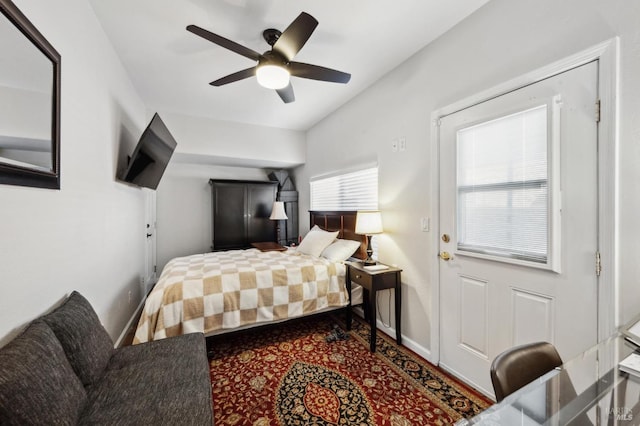 bedroom with ceiling fan and baseboards