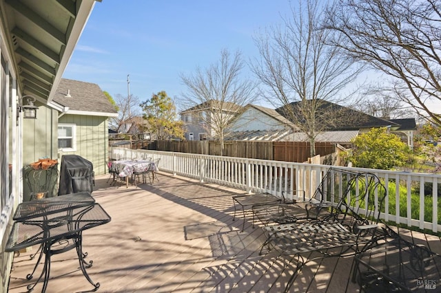 wooden terrace featuring grilling area and fence