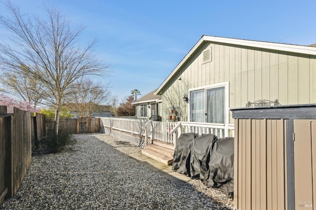 view of home's exterior with a deck and a fenced backyard