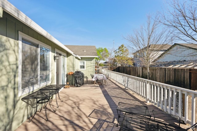 wooden deck featuring a fenced backyard and grilling area