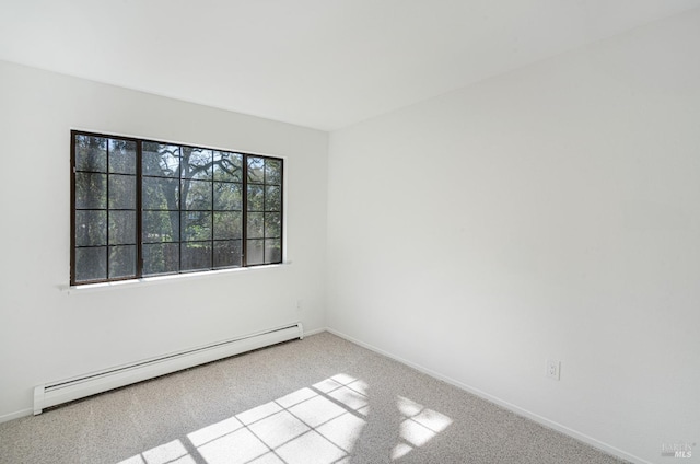 spare room featuring baseboards, carpet flooring, and baseboard heating