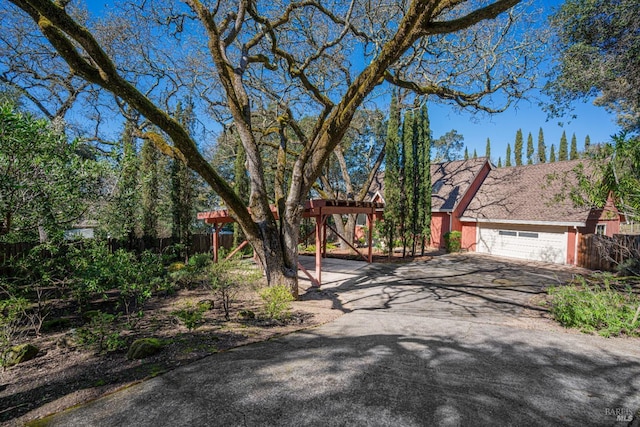 view of front of property featuring fence and driveway