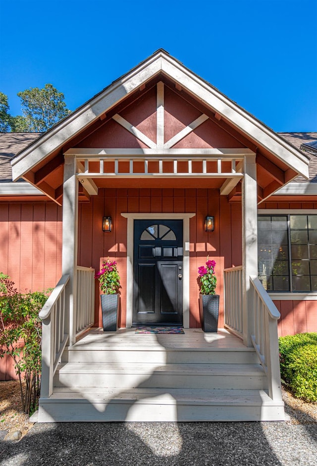 entrance to property featuring a porch and board and batten siding