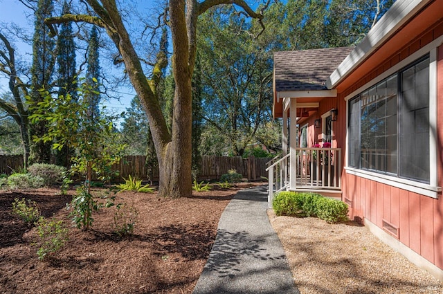 view of property exterior featuring crawl space, fence, and roof with shingles