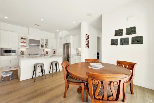 dining room featuring recessed lighting, visible vents, and light wood finished floors