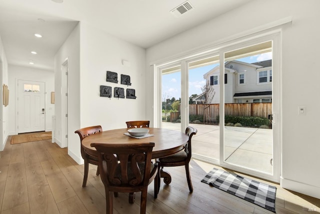 dining room with recessed lighting, visible vents, wood-type flooring, and baseboards