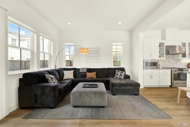 living room with recessed lighting and light wood-style floors