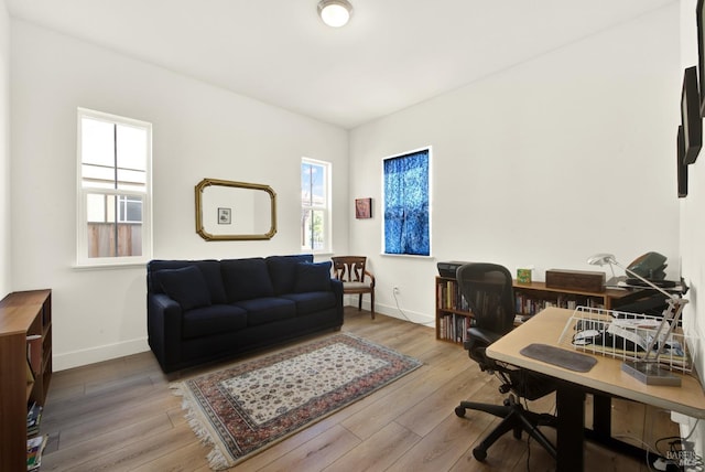 home office featuring baseboards and wood finished floors