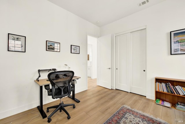 office space featuring visible vents, baseboards, and hardwood / wood-style flooring