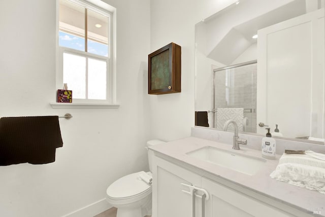 full bath with vanity, a shower stall, toilet, and baseboards