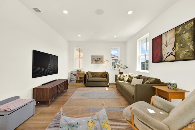 living area featuring recessed lighting, visible vents, and light wood-type flooring