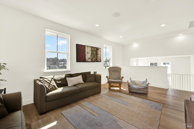 living room with visible vents, recessed lighting, baseboards, and wood finished floors